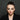 Model with a smudged, smoky gothic eye look against a dark background