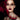 Gothic beauty portrait with smoky eyes and deep oxblood lips against a black background with a dramatic red splash