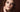 Moody close-up portrait of a model wearing a dark, smudged smoky eye