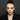 Model with a dark smoky halo eye and a shimmering centre, photographed against a black background