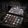 Til Death Palette open with mirror, showing 28 eyeshadow shades against a gothic graveyard backdrop
